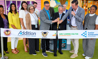Representatives from Addition Financial, Rosen Preschools, the Early Learning Coalition of Orange County and Junior Achievement of Central Florida participate in a ribbon-cutting ceremony for the ADDing FUNdamentals financial literacy program.