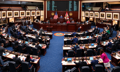 Wide view of the Florida House of Representatives chamber in Tallahassee with lawmakers seated at their desks during a legislative session.