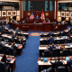 Wide view of the Florida House of Representatives chamber in Tallahassee with lawmakers seated at their desks during a legislative session.